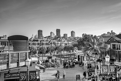 San Francisco, USA - May 18, 2022:  Tourists and locals enjoy the riverfront at Pier 39 with restaurants, shops and other touristic facilities.