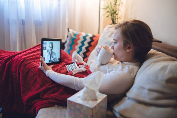 istock Young ill female having interaction with doctor over digital tablet 1406542651
