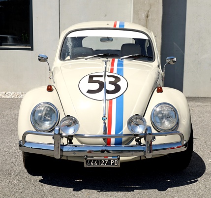 Azzida, Italy. July, 2 2022.  White Volkswagen Type 1 , known as beetle and  painted as Herbie of the film Love Bug, during a vintage car gathering