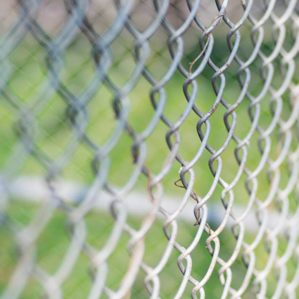 istock Close-up chain link fence , Sunset background 1406544280