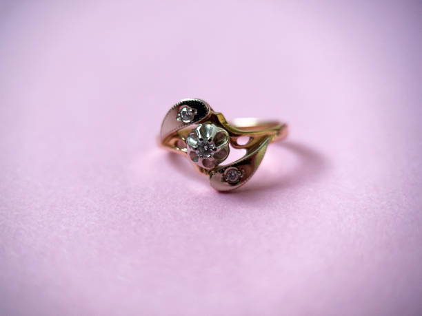 istock Gold diamond ring on pink isolated background. Red Gold Ring 1406544420