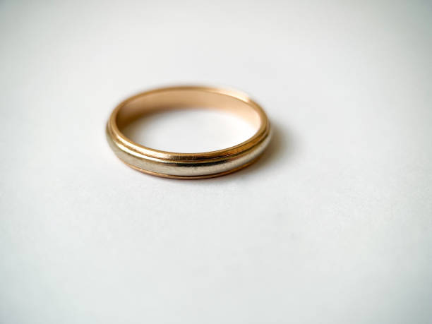 istock Gold wedding ring on a white isolated background. Red and white gold ring 1406544939