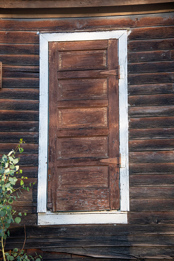 Old exterior door and wall on house in ghost town in wild west of Colorado in USA.