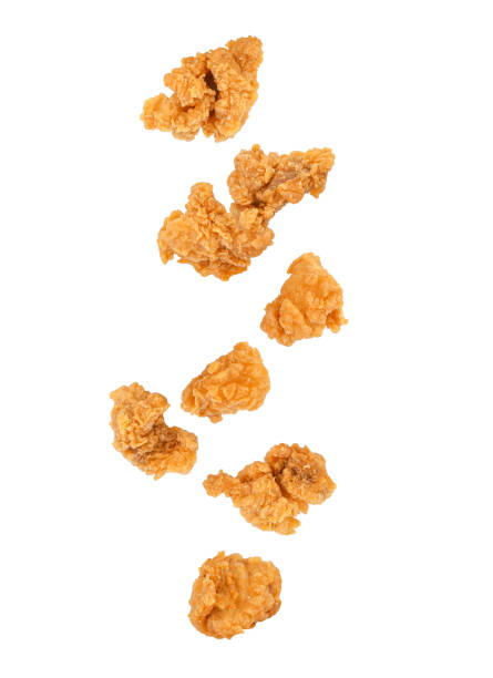 istock Fried popcorn chicken falling in the air isolated on white 1406547133