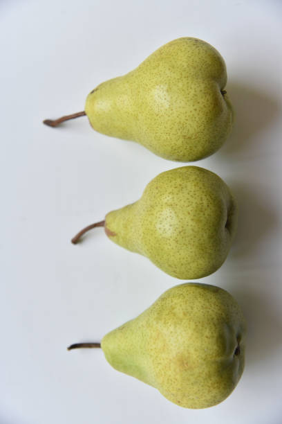 istock Three green juicy pears on a white background 1406549638