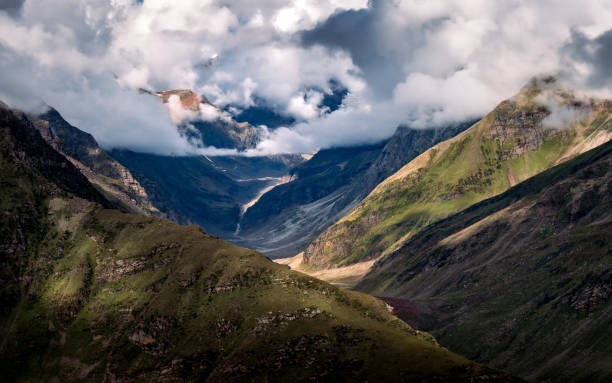 Mountain range with low clouds with dramatic sky, india stock photo