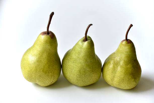 istock Three green juicy pears on a white background 1406550314