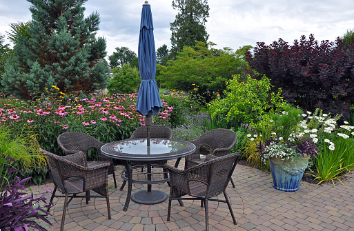 Lovely garden patio with table and wicker chairs