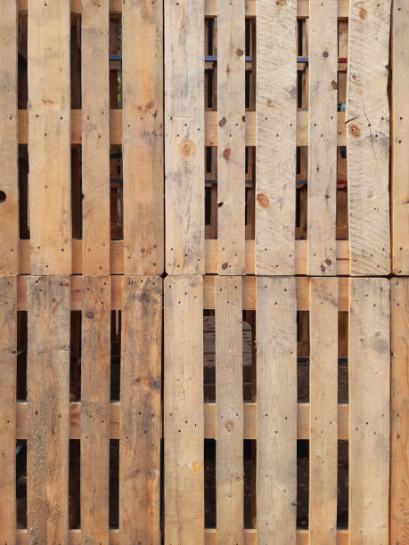 Pallet wall background. Eco-friendly full frame pallets. Wood Pallets plank texture background. Wall with overlapping pallets. Recycle crafts.