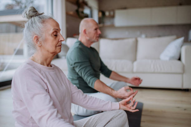 istock Senior couple doing relaxation exercise together at home. 1406553212