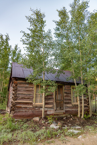 Wooden huts with rocky mountains in autumn forest at Assiniboine provincial park, BC, Canada