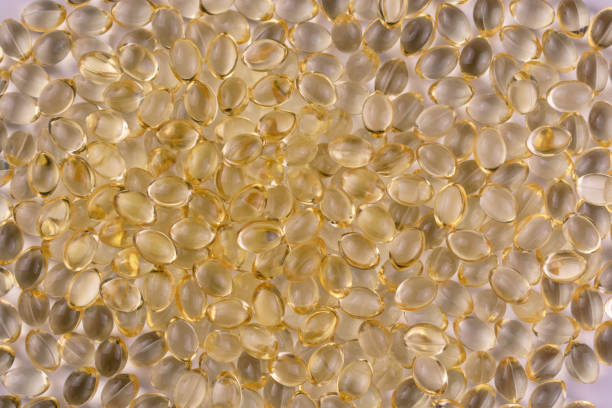 istock Vitamin D in transparent capsules. Background. 1406553648