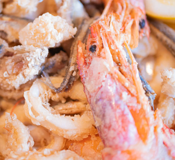 istock Typical Italian dish, mixed fried fresh fish with squid rings, sardines and shrimp 1406557235