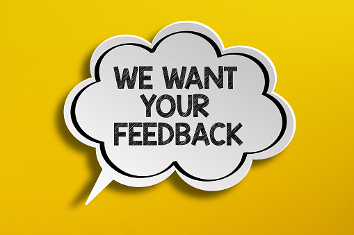 We Want Your Feedback written in speech bubble on yellow background