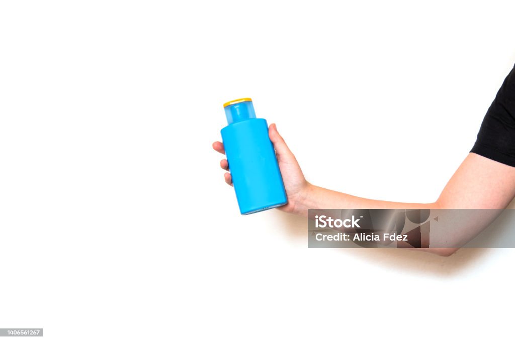 caucasian arm holding a bottle of sunscreen White caucasian arm holding a bottle of sunscreen, isolated on a white background Insect Stock Photo
