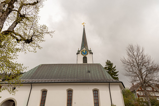 Wildhaus, Switzerland, May 5, 2022 Catholic church in the center on an overcast day in spring time