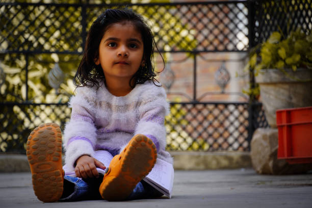 Frustrated young child sulking outdoor in the nature.