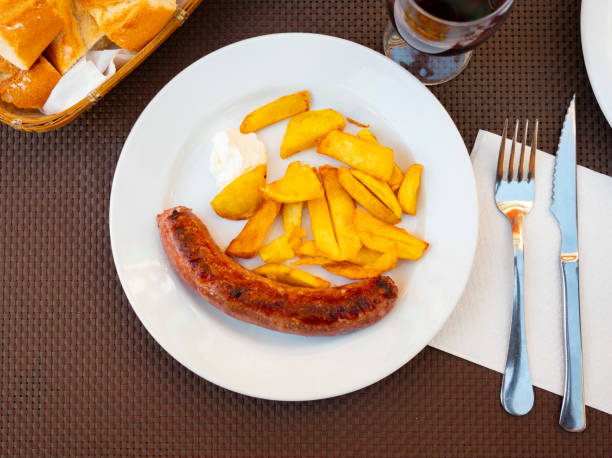 istock Juicy roasted botifarra with fried potatoes 1406564838
