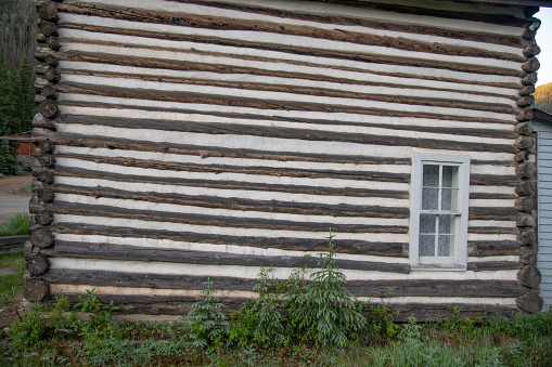 Old log cabin in gold mining ghost town in central wild west Colorado in western USA.
