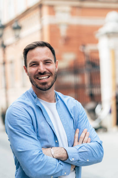 istock Smiling man outdoors in the city 1406568435
