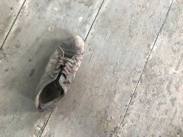istock Worn shoes on wooden floor 1406569833