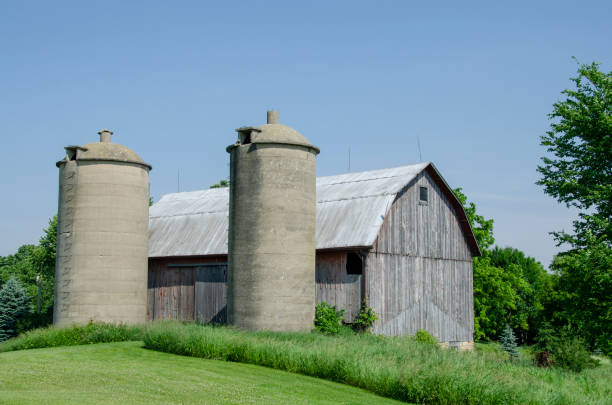 istock abandoned silos made of cement in front of old barn 1406571438