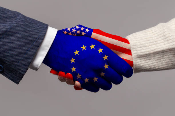 istock European Union and USA concept. Flags on handshake on gray background 1406572234