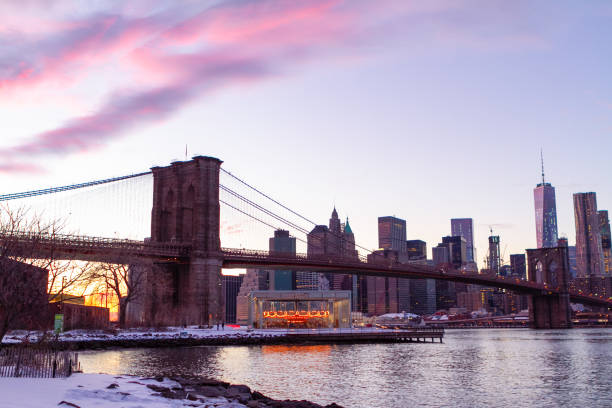 view of manhattan at dusk with the brooklyn bridge in the foreground - connection usa brooklyn bridge business imagens e fotografias de stock