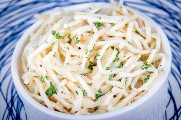 Celery Root Remoulade salad julienned Celery Root Remoulade salad julienned celeriac with a Dijon mustard dressing on a rustic table celery stock pictures, royalty-free photos & images