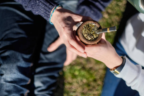 istock Women’s Hands Taking a Pumpkin with Mate: Traditional South American Drink 1406573084
