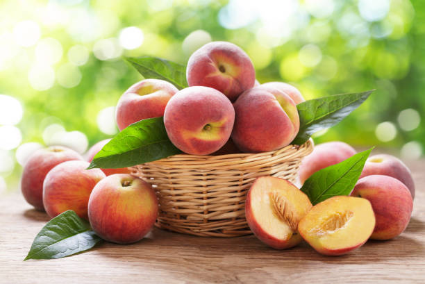 istock Basket of fresh peaches on a wooden table 1406575297
