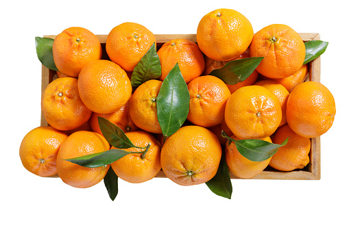 fresh ripe mandarin oranges fruit or tangerines in a wooden box isolated on white background, top view