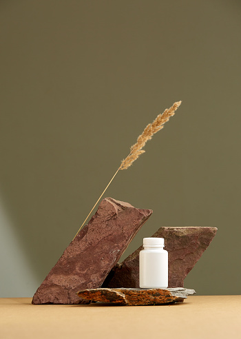 Podium of stone on a brown background and spikelet. Stones, spikelet, brown colour. Showcase for cosmetic. High quality photo