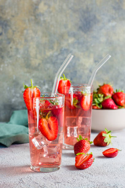 istock Refreshing cocktail with strawberries in glasses with a straw on the table. Vertical view 1406577856