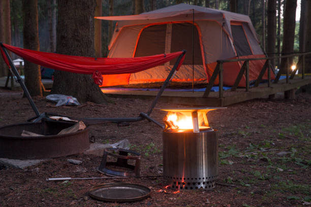 istock Solo stove with hammock and camping tent at the campground 1406578862