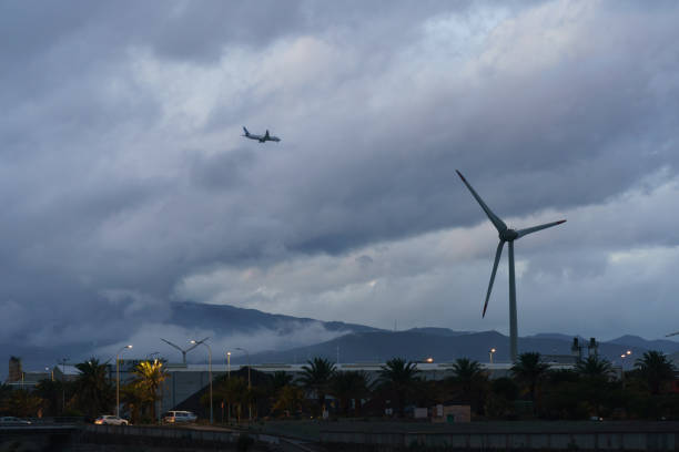Gran Canaria, Spain - November 17 2018: Lanscape in sunset time. Aircraft flying. Low clowds. Traffic on the motorway
