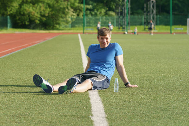 istock Handsome man resting after training at a stadium in Moscow city. 1406580298