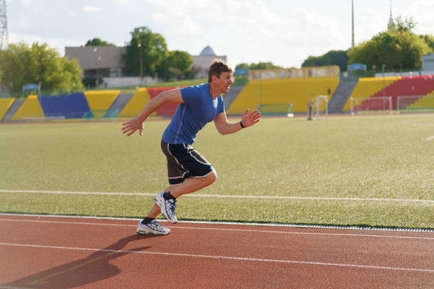 istock Handsome man jogging at a stadium in Moscow city. 1406580418