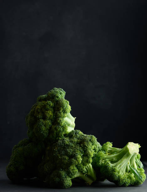 istock Fresh green head of broccoli on black background 1406582508