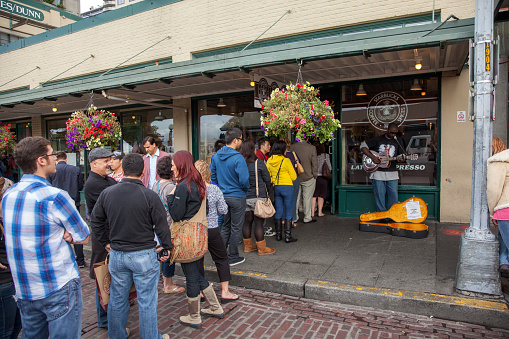 Seattle, WA - September 18, 2011: Customers queuing for coffee at the original Starbucks coffee shop in Seattle, Washington.