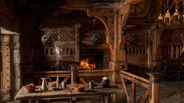 istock Dining table by a window in an old medieval tavern with fire burning in the background. 3D rendering. 1406584329