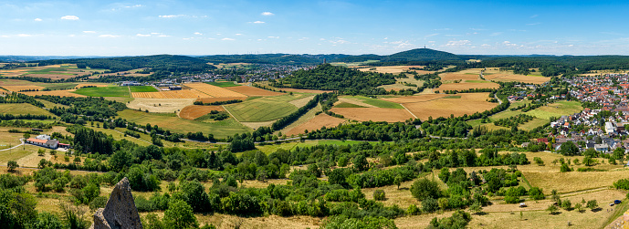 Overview of the central Hessian municipality of Krofdorf-Gleiberg in a panoramic view in sunny summer weather with horizon, cloudless sky, the ruins of Vetzberg Castle with its keep and agricultural surroundings