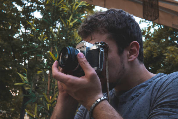 istock Guy sitting and taking a picture with a camera. Photography 1406588559
