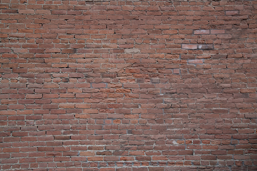 Very old brick wall in old west town in central Colorado, USA.