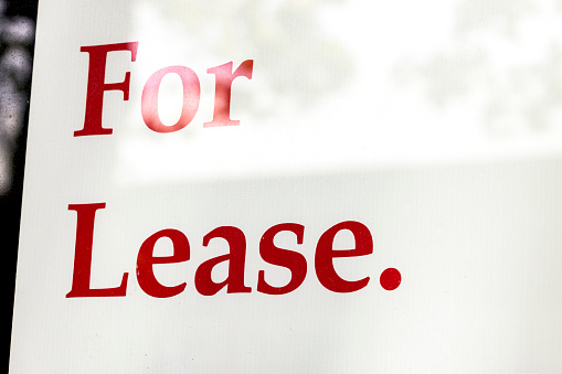 Sign behind the window “For Lease” background with copy space, full frame horizontal composition