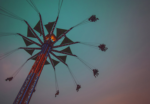 fair swing ride at dusk toned with a retro vintage instagram filter
