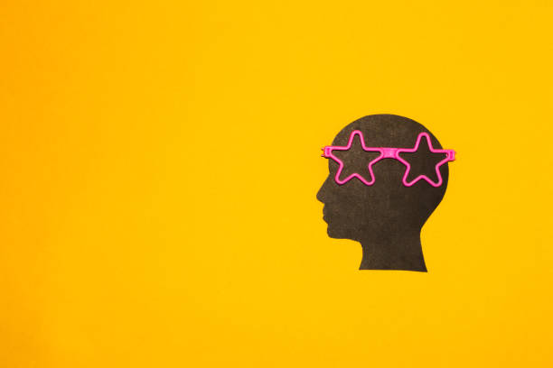 istock black head with pink star glasses on yellow background, creative art design 1406592096