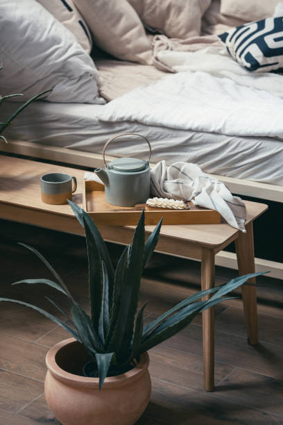 istock Dessert, tea cup and teapot on breakfast tray, against bed 1406593164