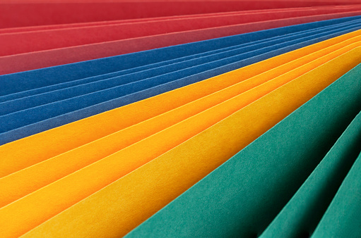 Stack of Colorful Post it Notes on Green Background