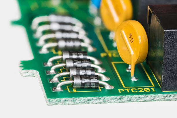 istock Semiconductor diodes and yellow resettable fuses in PCB detail on a white background 1406593454